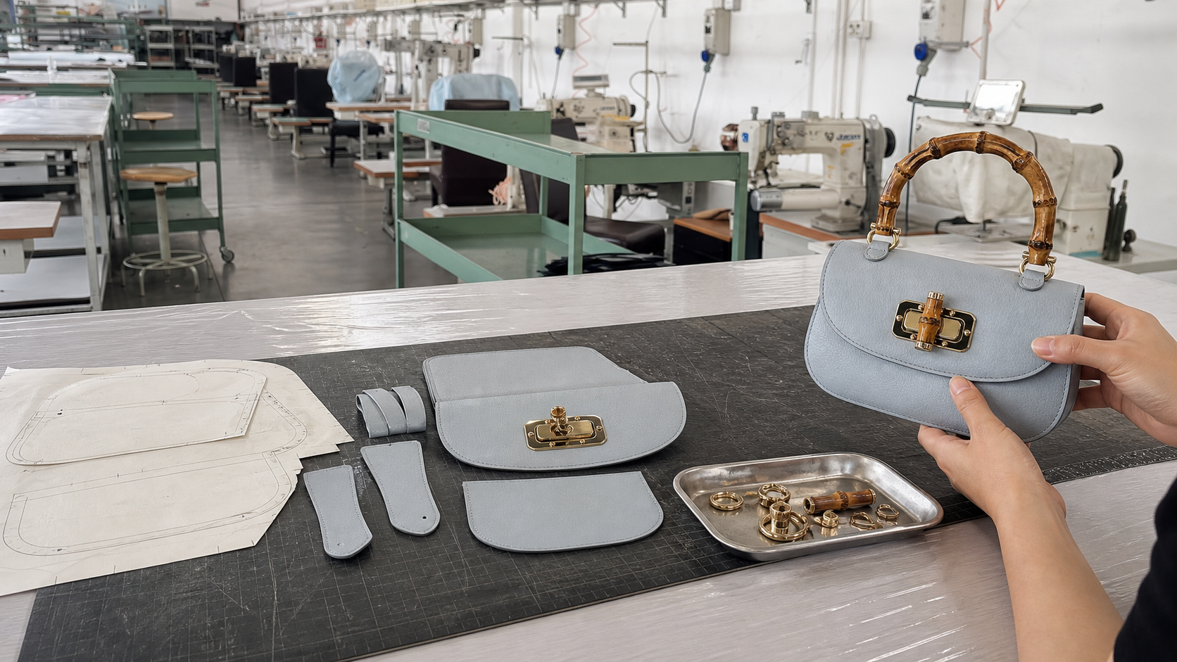 Technical drawings, patterns, material references and sample bags arranged in production sequence